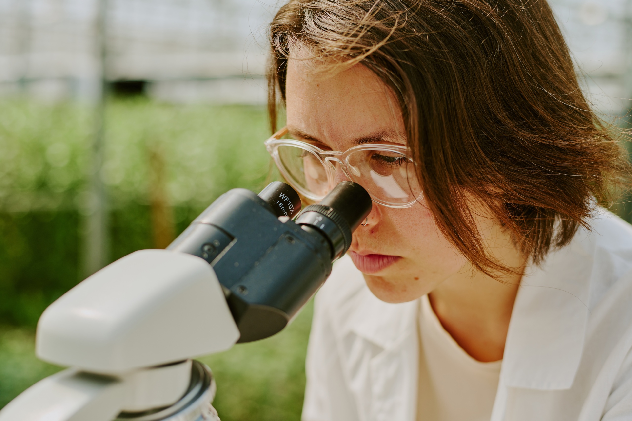 scientist using microscope in lab