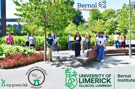 an outdoor group photo featuring logos from multiple science-related companies