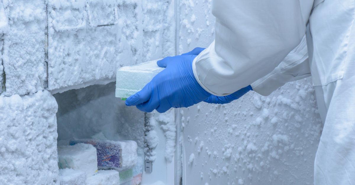 lab worker placing materials into a freezer