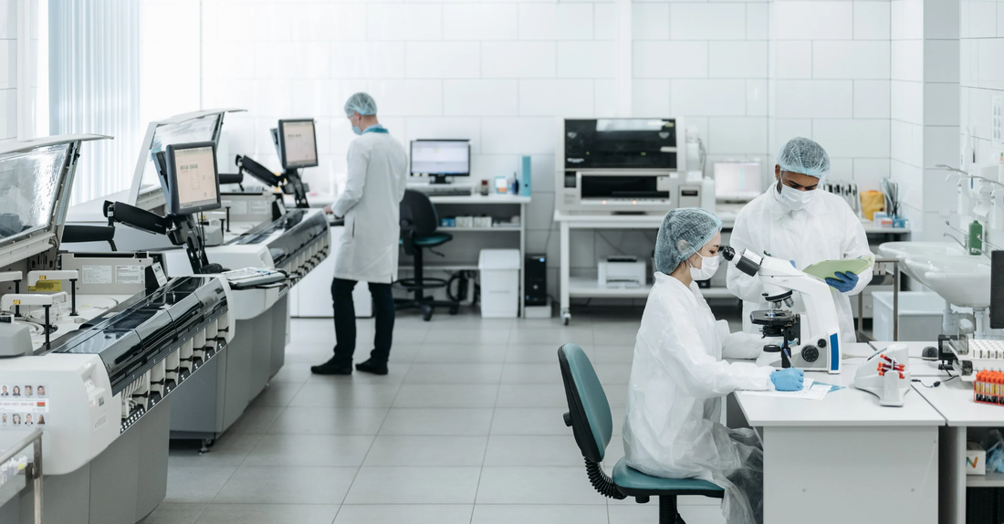 three people working in a laboratory