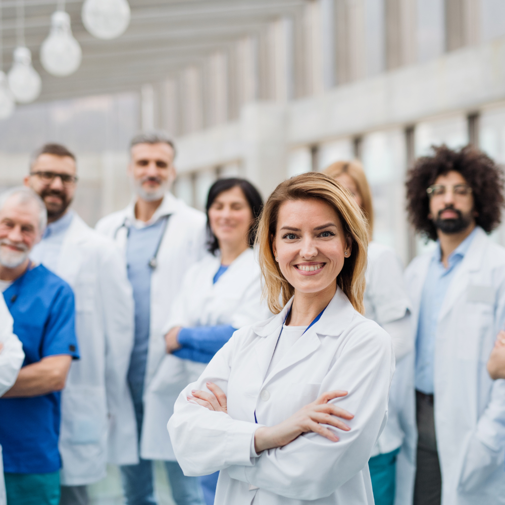 group of people in lab coats smiling at the camera