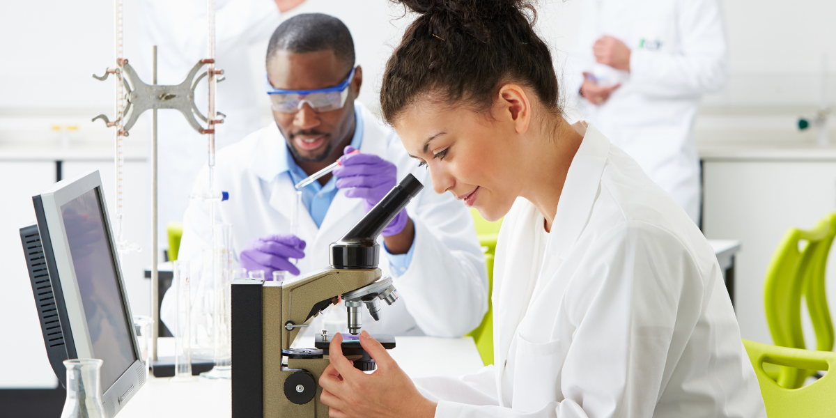 scientists looking into mircoscope